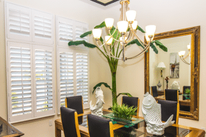 A beautifully staged dining set, bathed in natural light by perfectly installed dining room window treatments